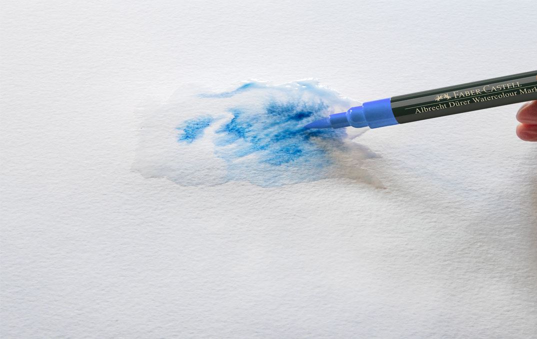A blue watercolour marker mixing colour wet in wet.