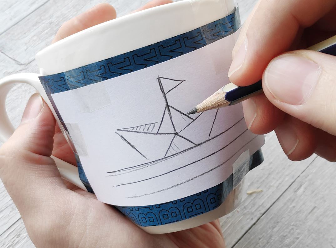 A drawn paper boat put on a cup.